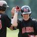 Milan High School senior Evan Peacock high-fives teammate junior Isaac Grubke during the fifth inning of the MHSAA baseball quarterfinals against Coldwater High School at Nichols Field at Bailey Park in Battle Creek on Tuesday, June 11, 2013. Melanie Maxwell | AnnArbor.com